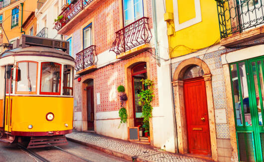 Yellow vintage tram on the street in Lisbon, Portugal.