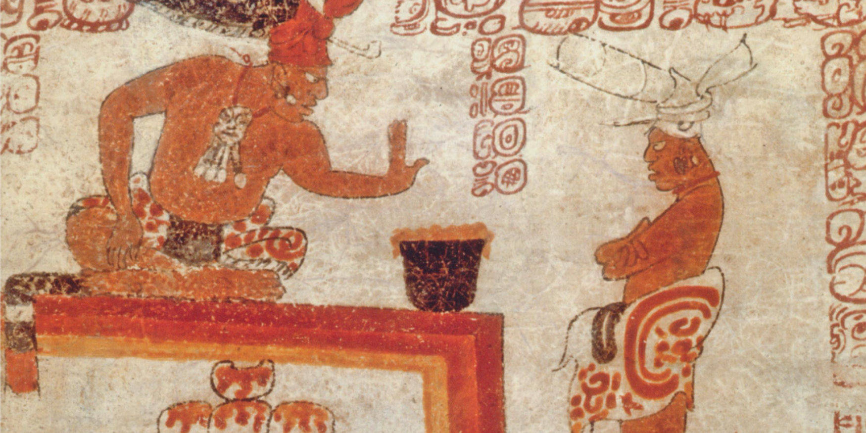 twee Maya-figuren en hete chocolade